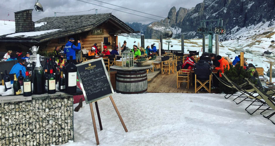 Eating Italian Food and drinking good wine at lunch is all part of the Italian ski experience, such as this restaurant on the Sella Ronda route. Photo: Scout