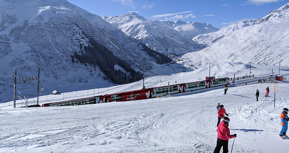 The Glacier Express train winds its way along the ski slopes of Andermatt SkiArena. Photo: Scout