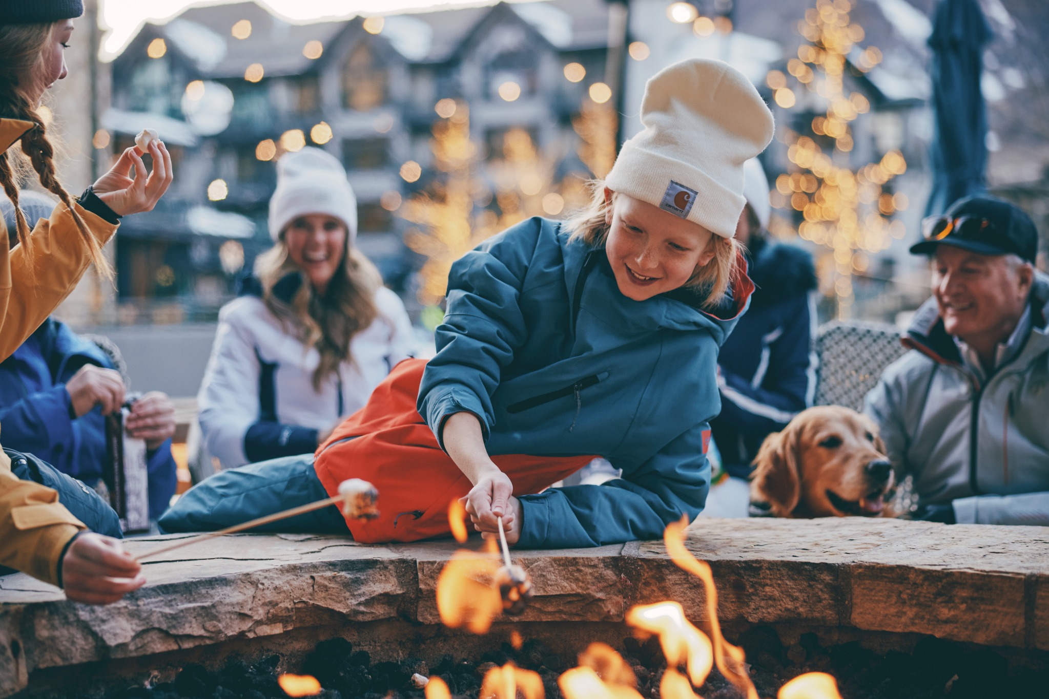 A child roasting marshmallows with family in Aspen Snowmass